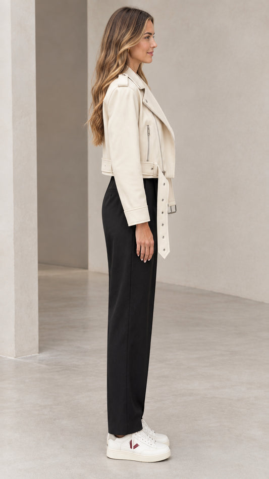 Side profile of woman wearing off-white cropped faux leather biker jacket