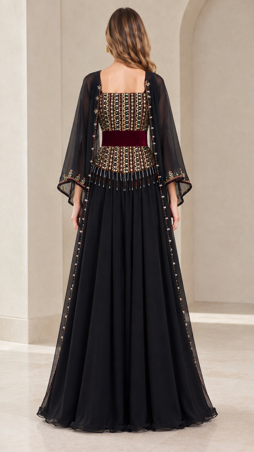 Back view of model wearing black chiffon formal gown with cape sleeves