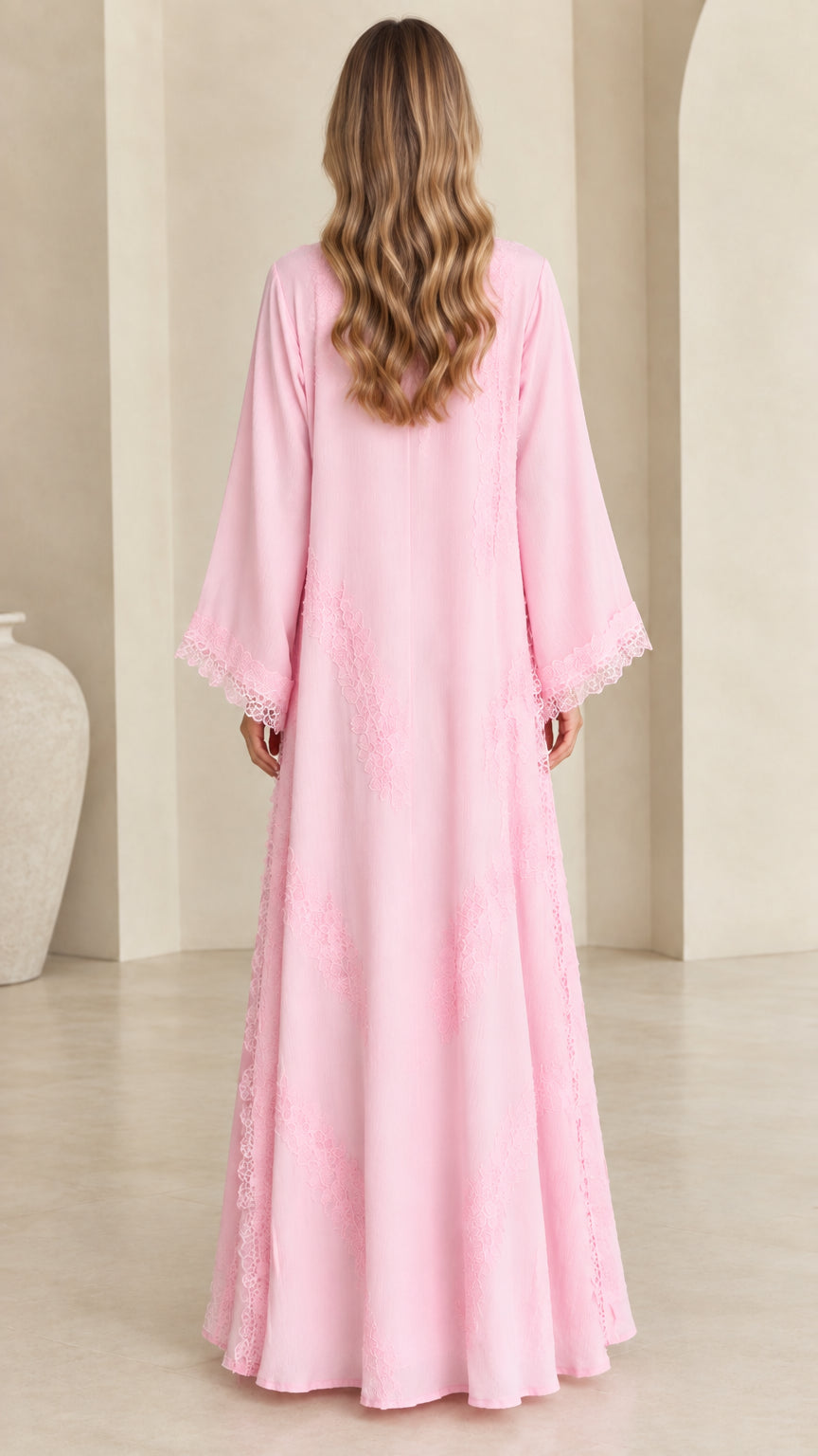 Back view of model wearing floor-length pastel pink open abaya cardigan