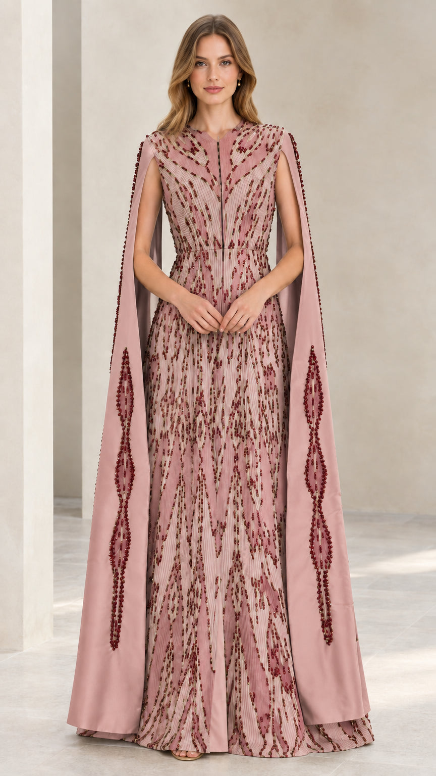 Model wearing dusty rose pink beaded cape sleeve evening dress