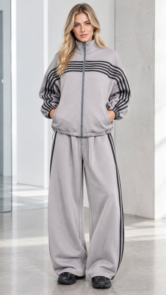 Front full view of woman wearing Heather Grey striped zip-up track jacket and wide-leg sweatpants set
