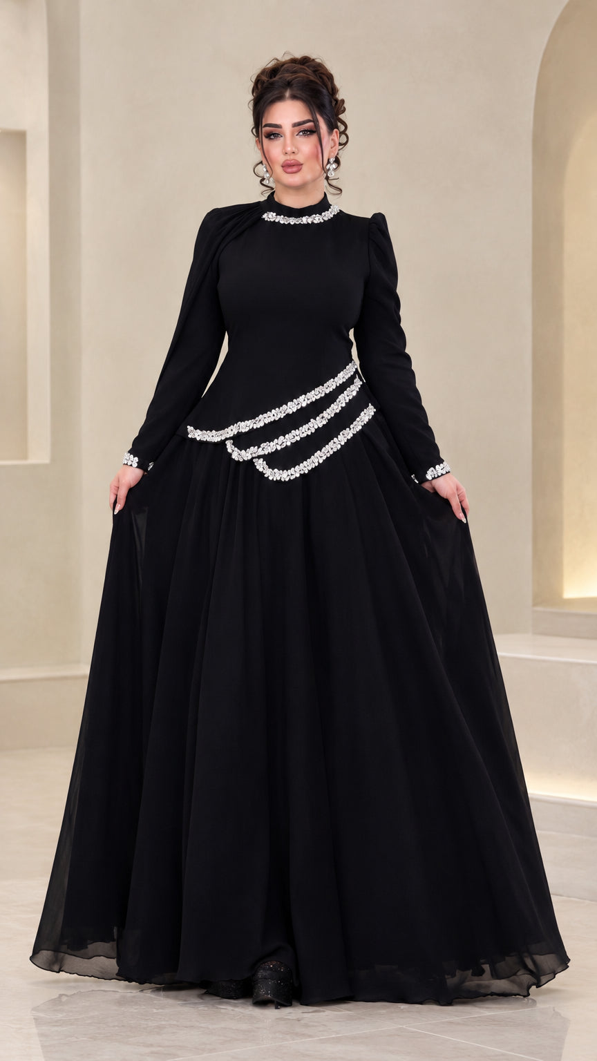 Front view of model wearing black rhinestone long sleeve chiffon evening gown
