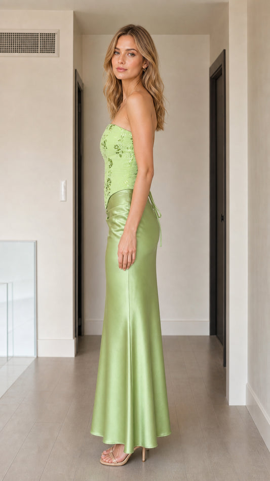 Side profile view of woman wearing sage green corset satin formal gown