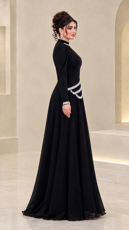 Side profile view of black modest long sleeve evening gown