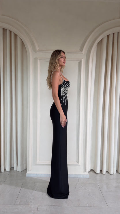 Black embellished formal column gown side view showing sleek silhouette