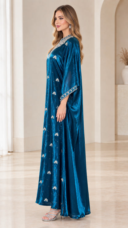 Side profile view of teal blue velvet kaftan maxi dress highlighting relaxed drape