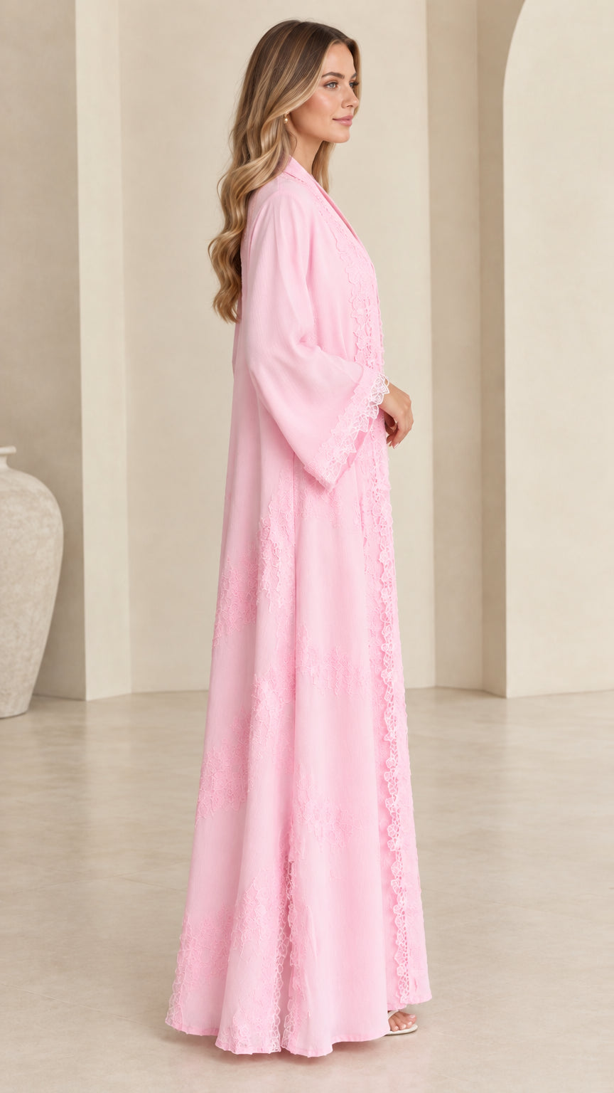 Side profile view of women's flowing pink maxi kimono duster with lace trim