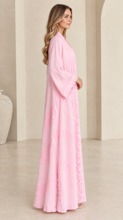 Side profile view of women's flowing pink maxi kimono duster with lace trim