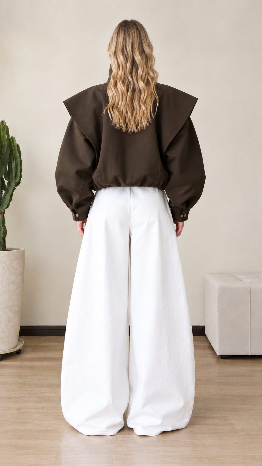 Back full view of dark brown relaxed-fit jacket showing drop shoulders and cape back overlay