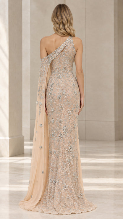 Back view of champagne floor-length lace evening dress with flowing cape and open-shoulder detail