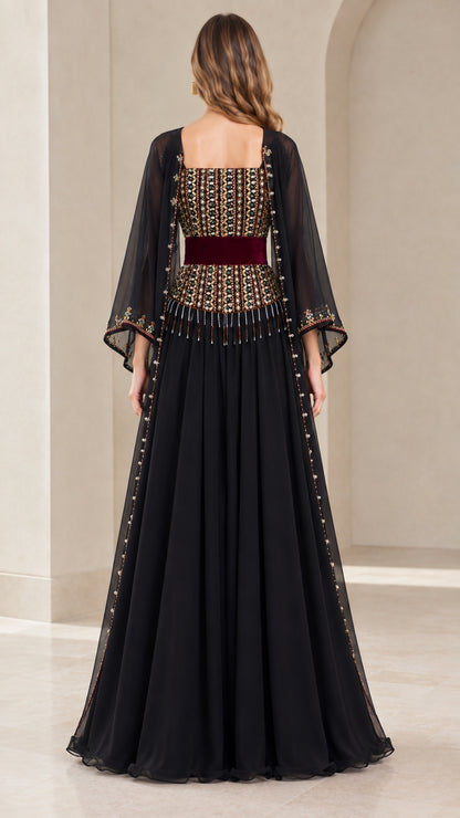 Back view of model wearing black chiffon formal gown with cape sleeves