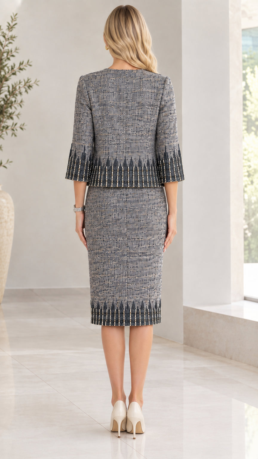 Back view of women wearing slate grey tweed skirt suit