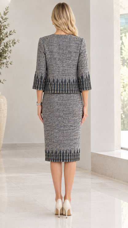 Back view of women wearing slate grey tweed skirt suit