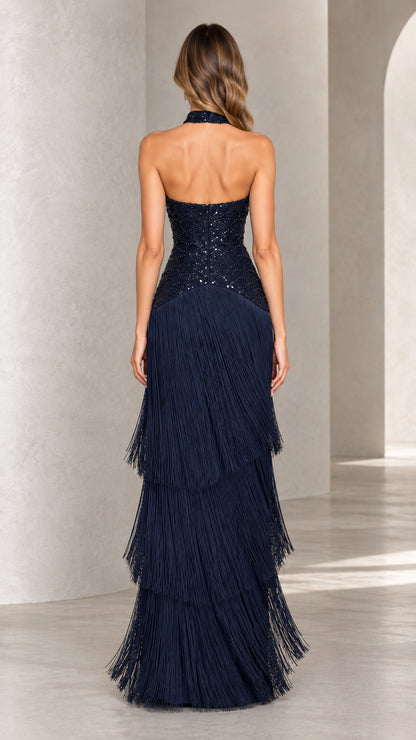 Back view of navy blue open-back halter tiered fringe formal gown