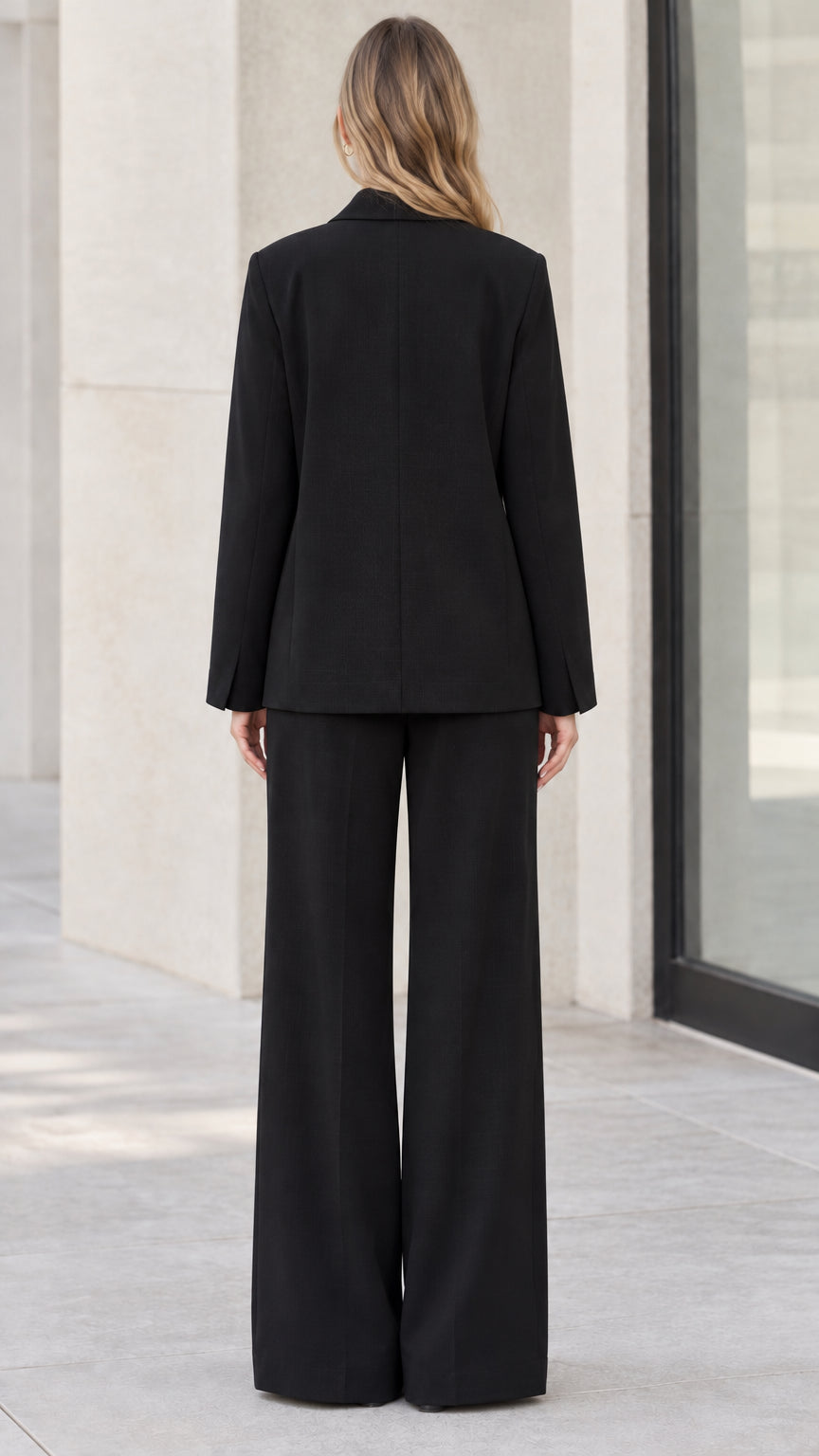 Back full-length view of black tailored blazer and wide-leg trousers