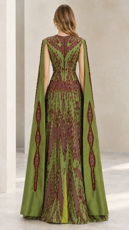 Back view of model in olive green beaded cape sleeve evening dress