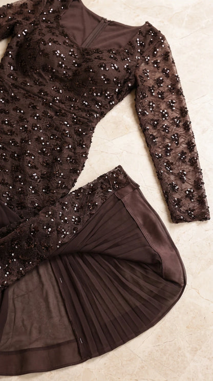Close-up detail of sequined floral embroidery and pleated chiffon skirt godet
