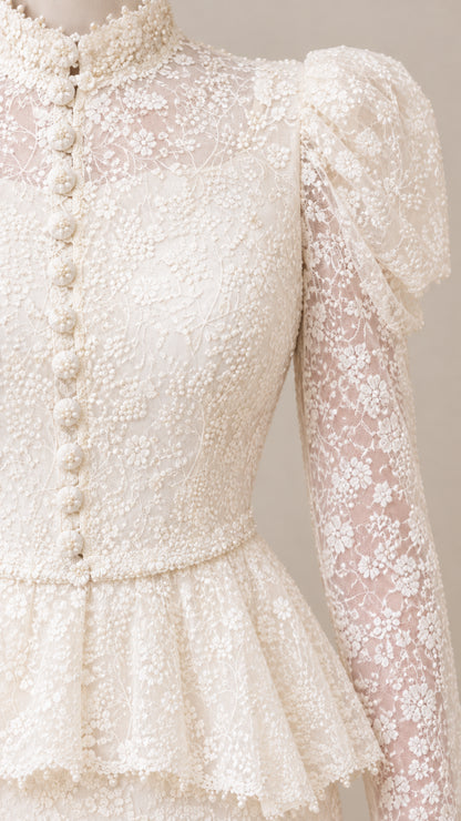 Close-up detail of Cream lace mock neck, front buttons, and peplum waist