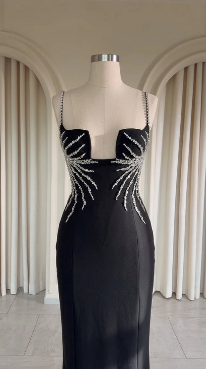 Close up of black evening dress structured notched neckline with crystal rhinestone embellishments on mannequin