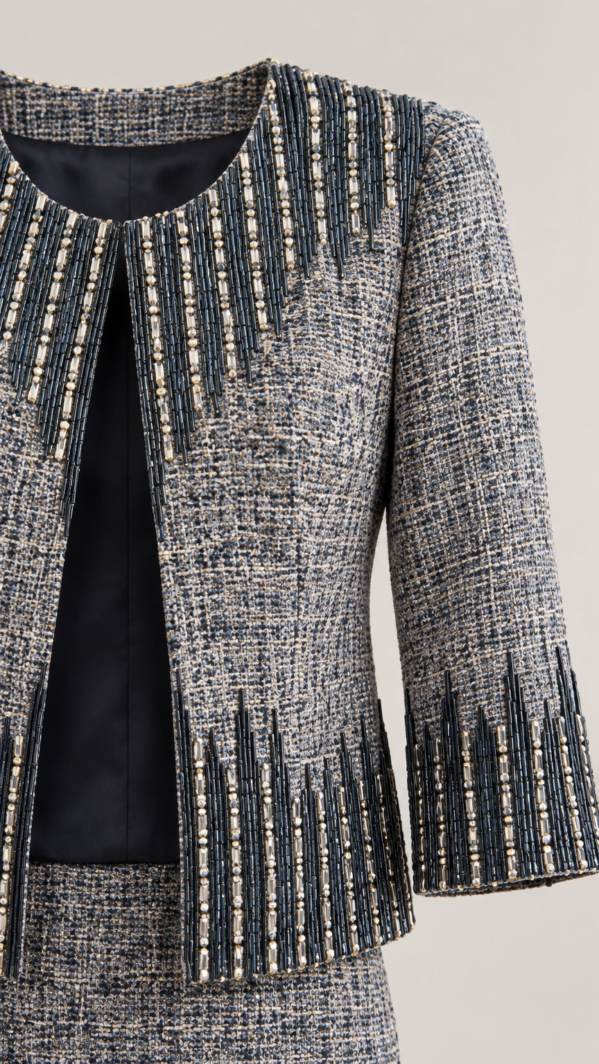 Close-up detail of woven tweed fabric, lining, and intricate beaded trim