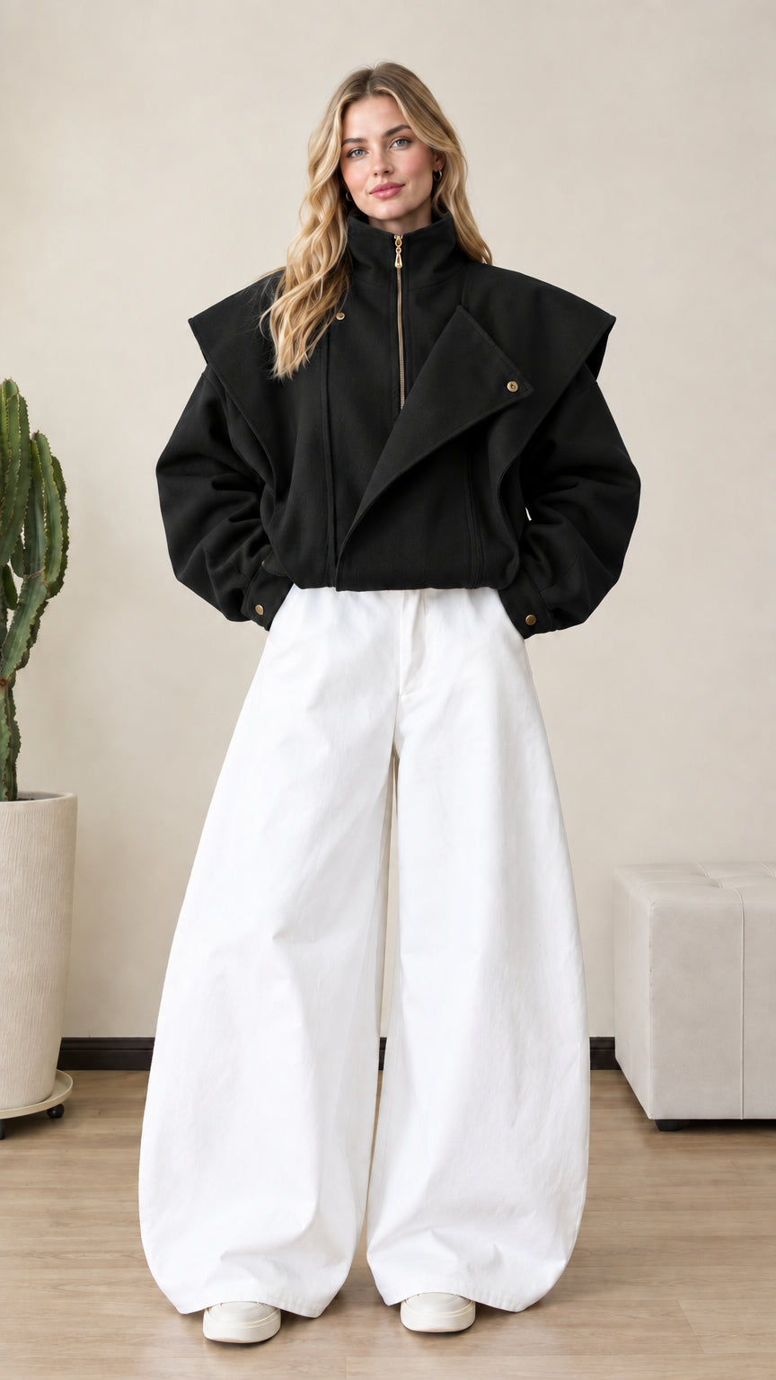 Front view of woman wearing black asymmetrical flap zip-up bomber jacket