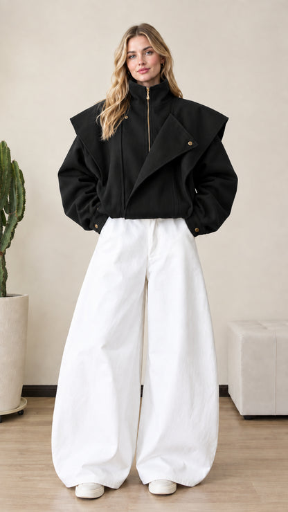 Front view of woman wearing black asymmetrical flap zip-up bomber jacket