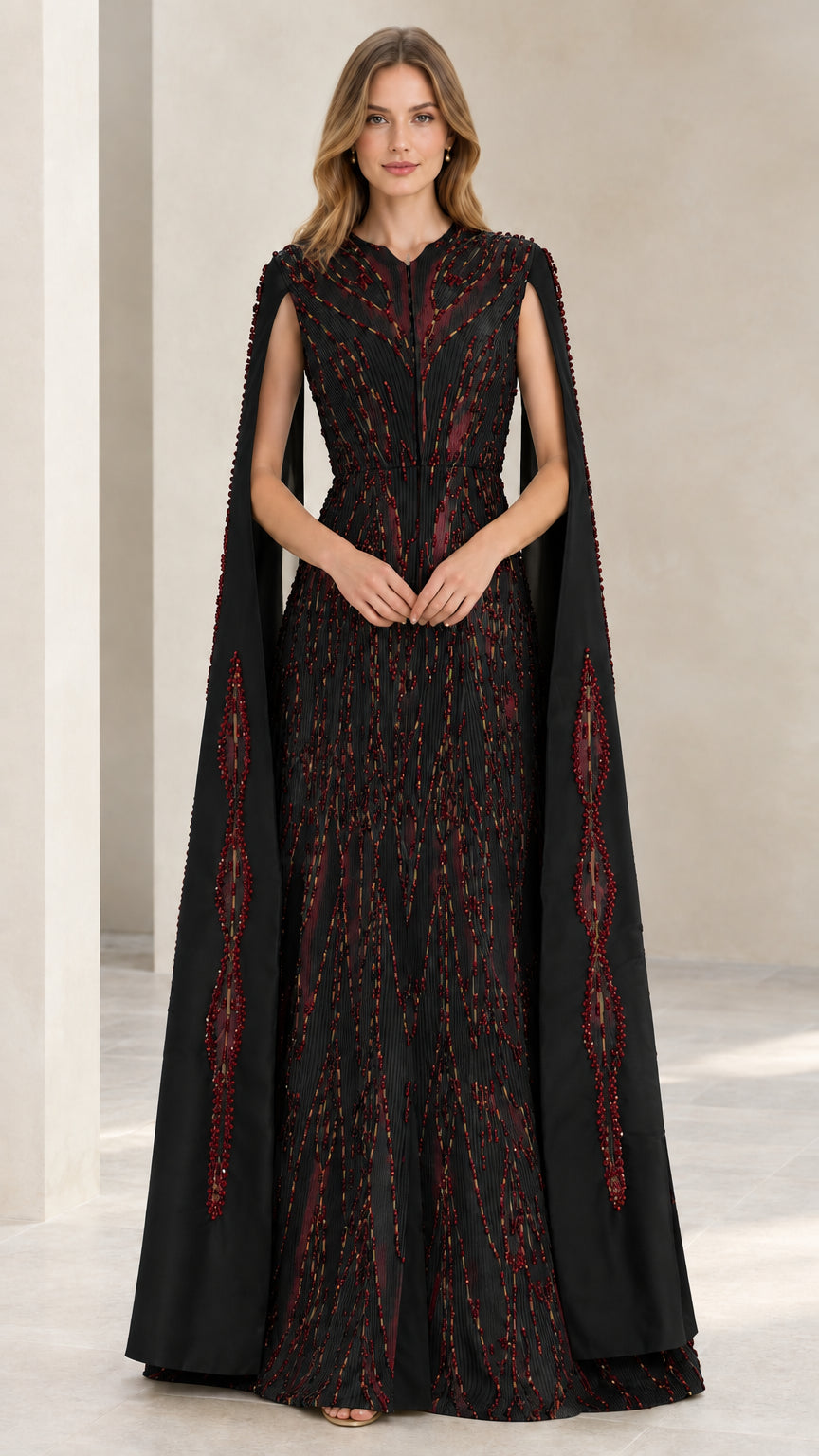 Model wearing black beaded cape sleeve evening gown