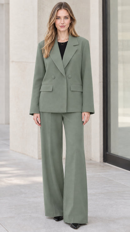 Full-length front view of model wearing sage green two-piece blazer and wide-leg trousers set