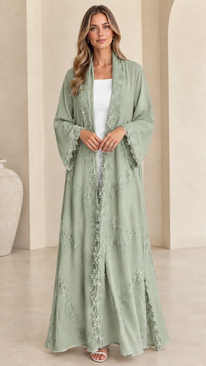 Front view of model wearing soft sage green lace trim open maxi abaya