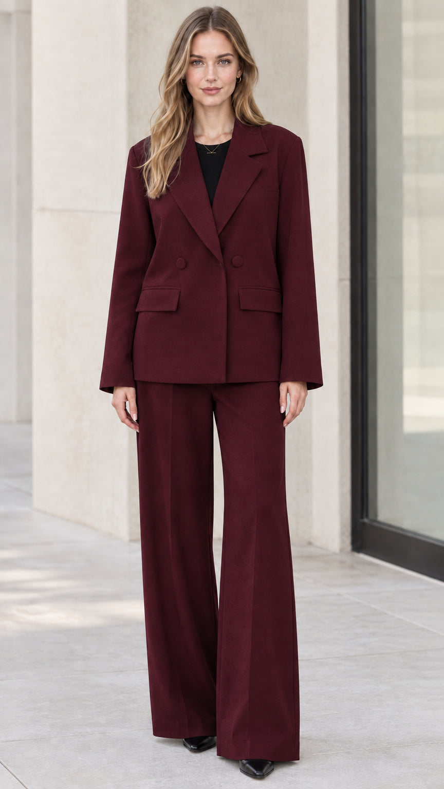 Full-length front view of model wearing burgundy wine two-piece blazer and wide-leg trousers set