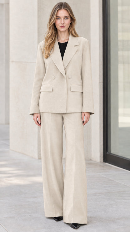Full-length front view of model wearing beige cream two-piece blazer and wide-leg trousers set