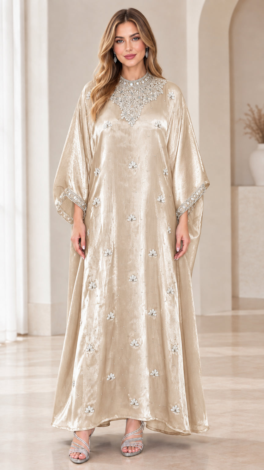 Model wearing champagne velvet kaftan maxi dress with sparkling embellishments