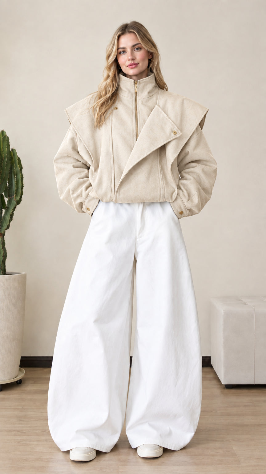 Front view of woman wearing beige cream asymmetrical zip-up bomber jacket